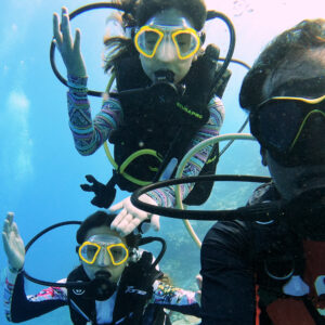 three person underwater